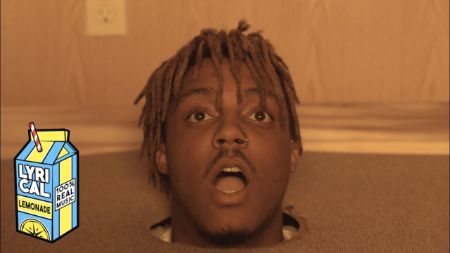 Juice Wrld peeking out of a hole on the ground in the music video of lucid dream